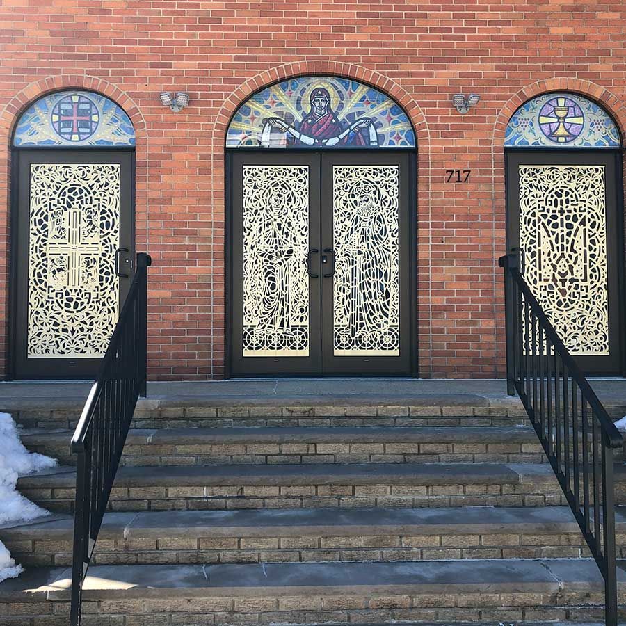 A brick building with arched doors and stairs leading up to them