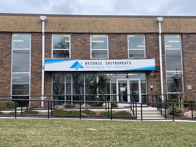 A large brick building with a sign that says avionic instruments