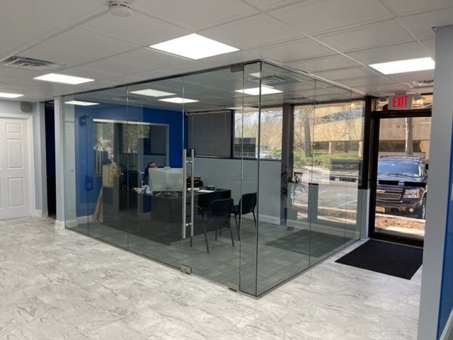 A room with a lot of glass walls and a door.