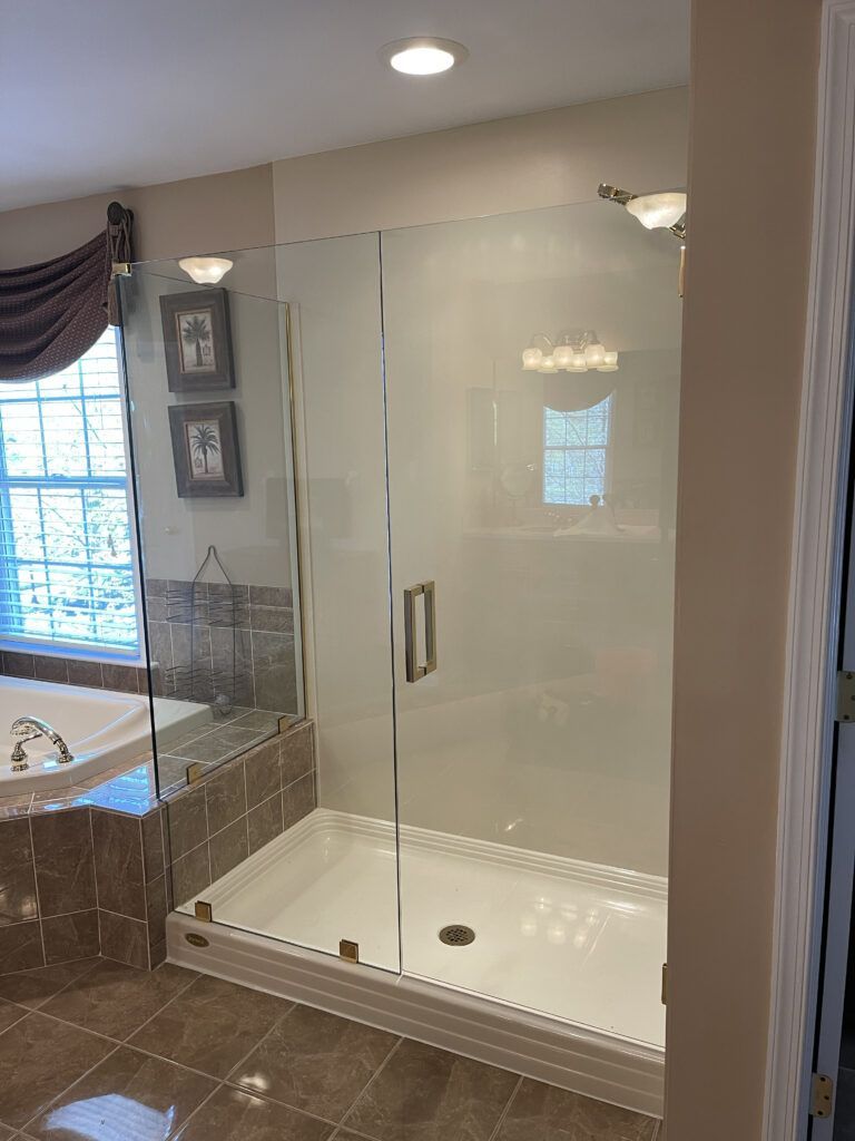 A bathroom with a walk in shower and a bathtub.