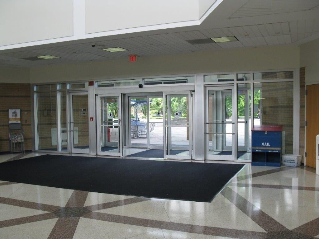 A large entrance to a building with a red exit sign above it