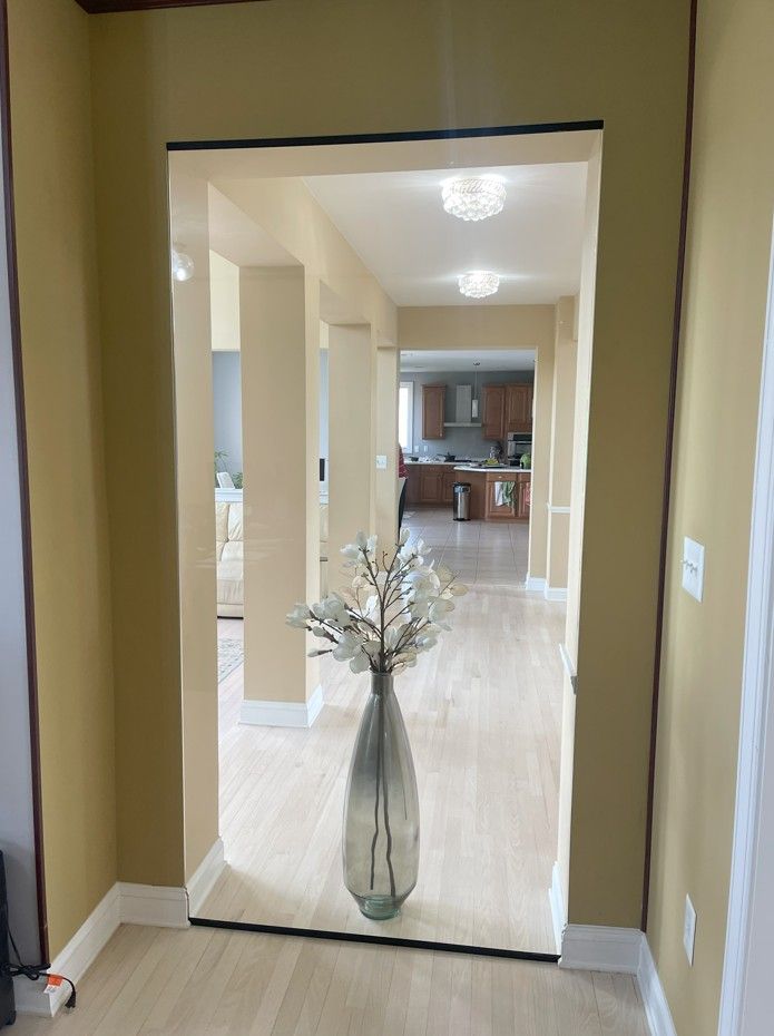 A hallway with a vase of flowers in it