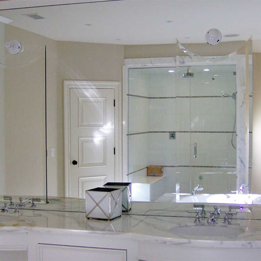 A bathroom with two sinks and a large mirror