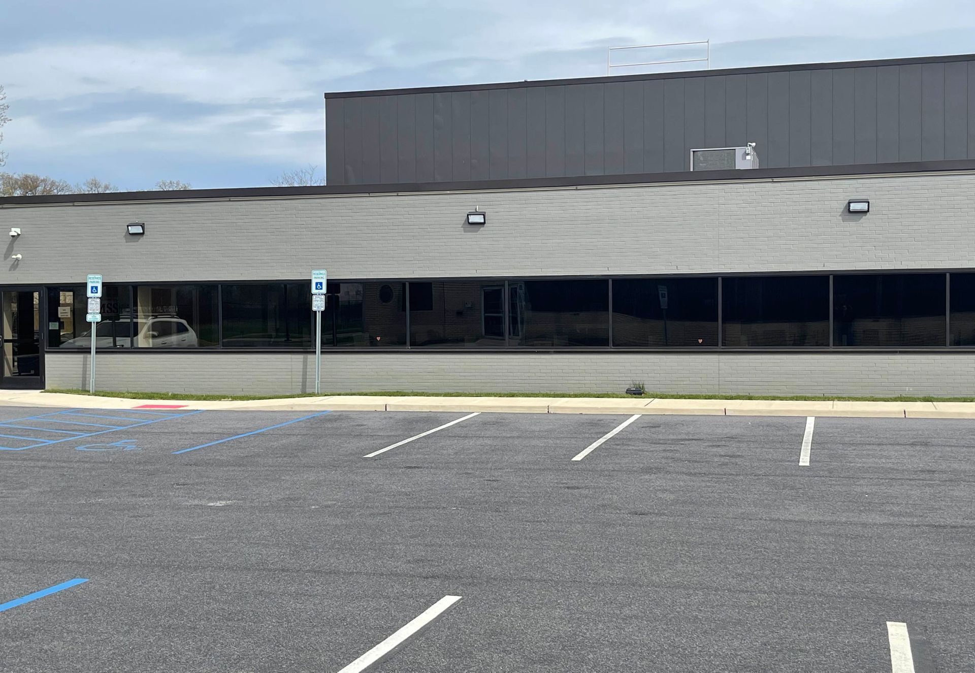 A large building with a parking lot in front of it.