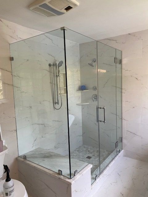 A bathroom with a walk in shower and a toilet.