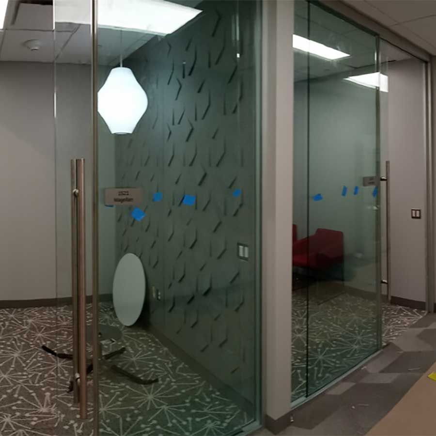 A room with a glass door and a round table in it.