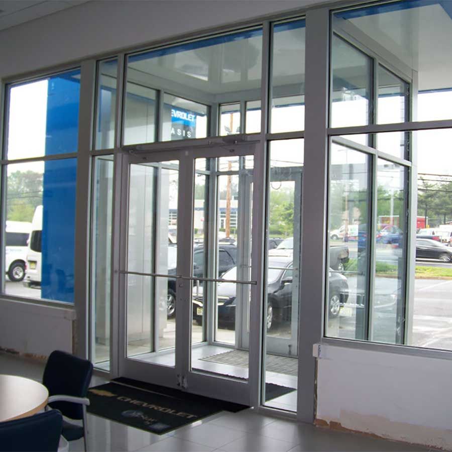 A room with a table and chairs and a door that says chevrolet on it