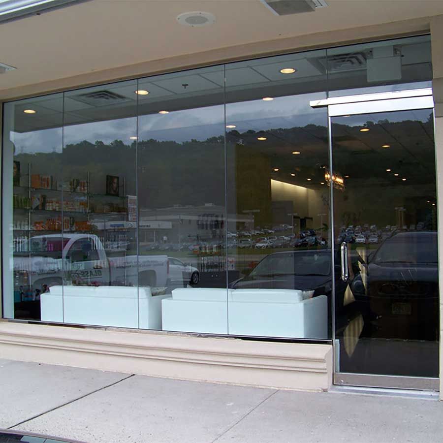 A store front with a glass door and a lot of windows