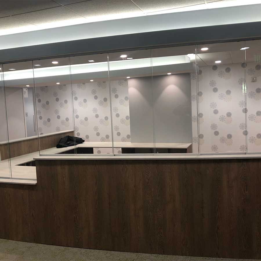 A large room with a wooden counter and a glass wall.