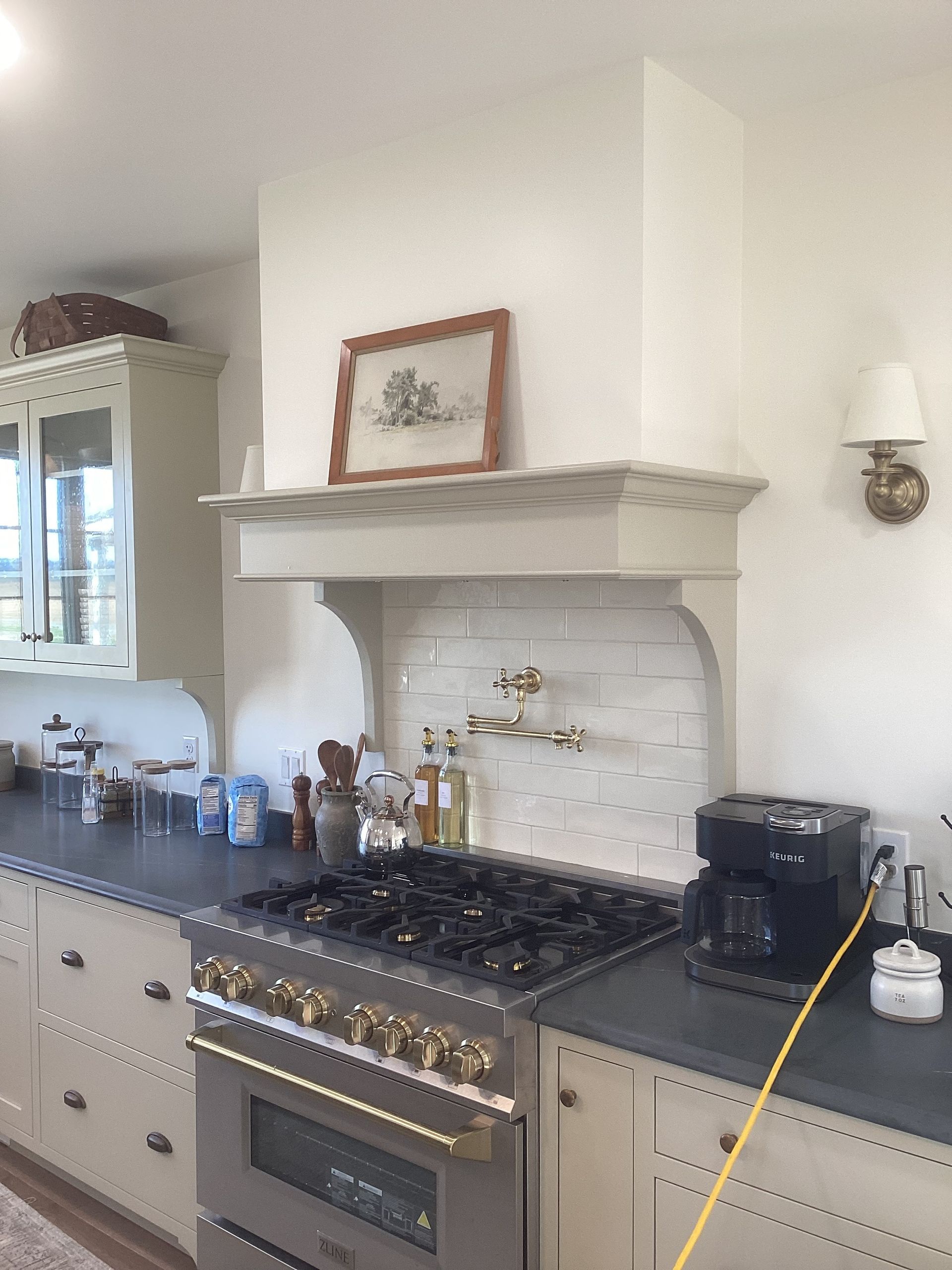 A kitchen with a stove top oven and a coffee maker