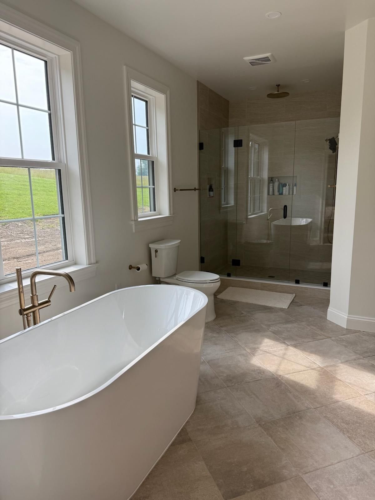 A bathroom with a tub, toilet, sink, and shower.