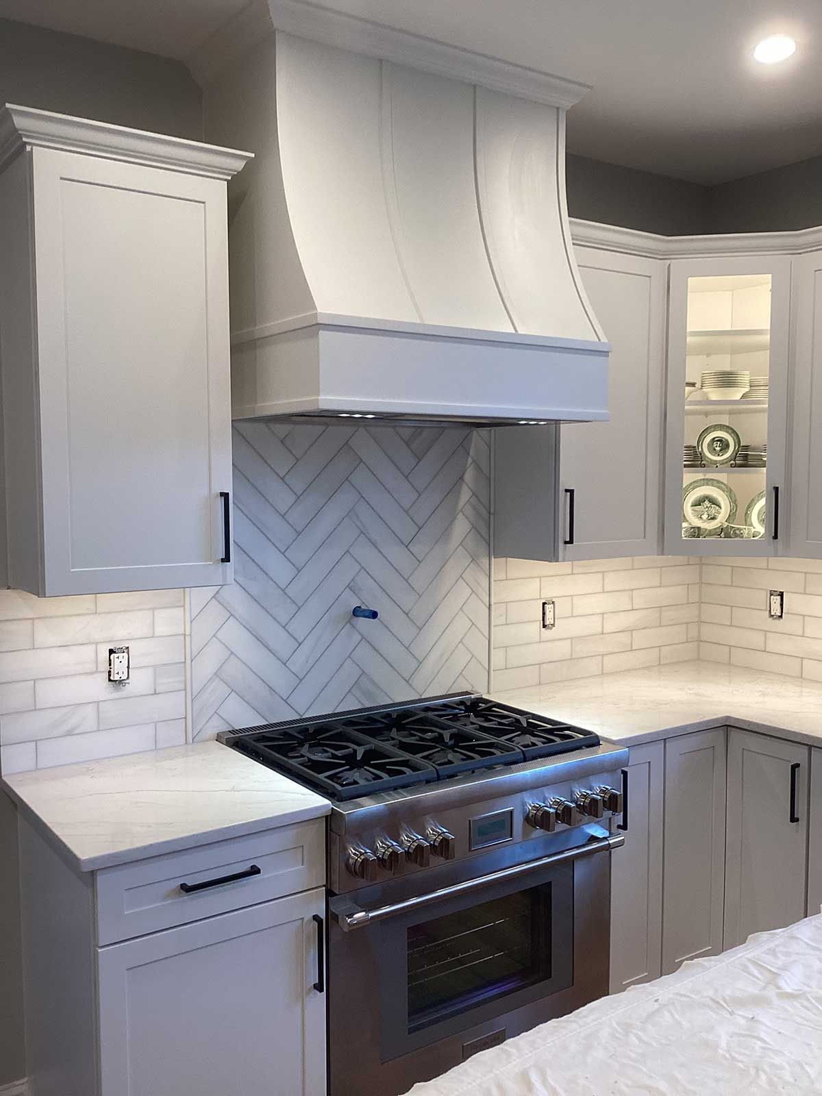 A kitchen with stainless steel appliances and white cabinets