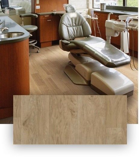 A dental office with a chair and a sink