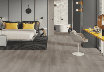 A bedroom with a bed , chair , desk , and bathtub.