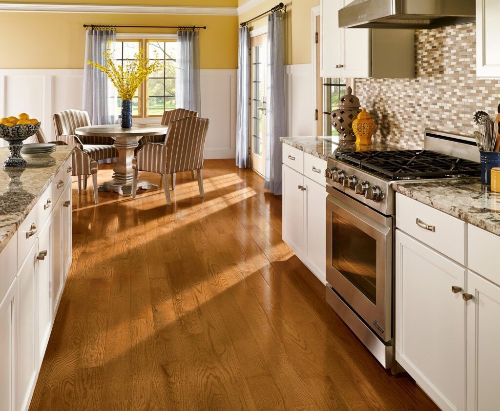 A kitchen with hardwood floors and stainless steel appliances