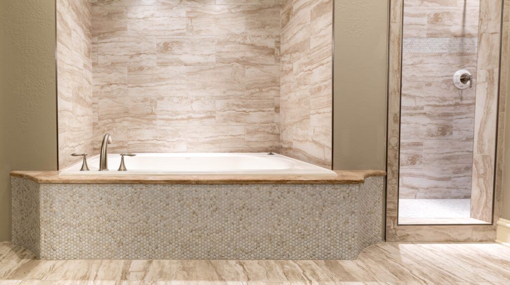 A bathroom with a tub and a walk in shower.