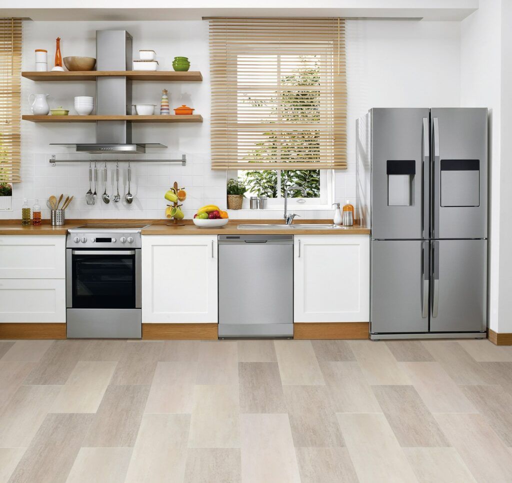 A kitchen with stainless steel appliances and white cabinets