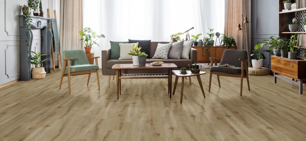 A living room with hardwood floors , a couch , chairs , and a table.
