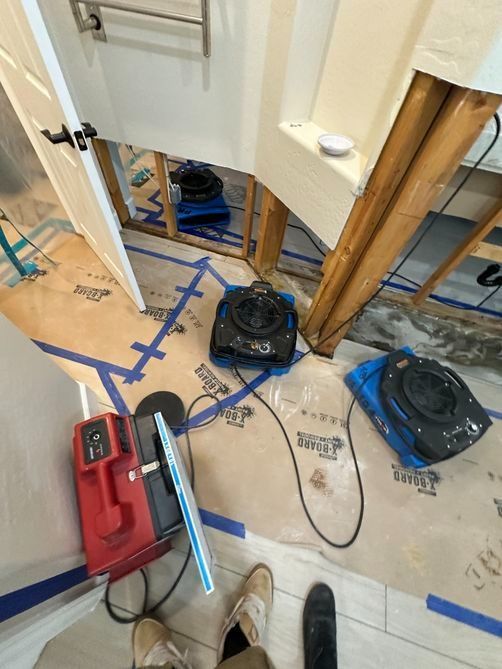 Renovation floor with blue tape, tools, and a doorway opening under construction