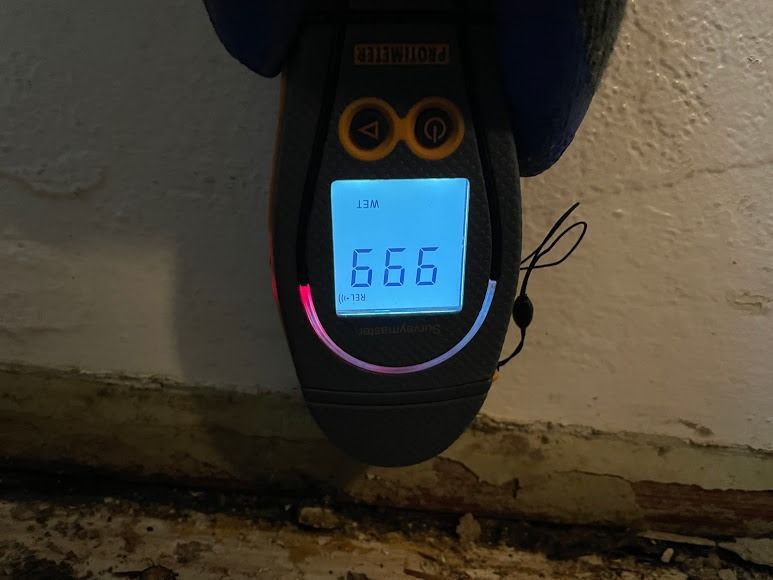 Close-up of a digital meter on a dark device, showing a blue-lit screen reading 6.66.