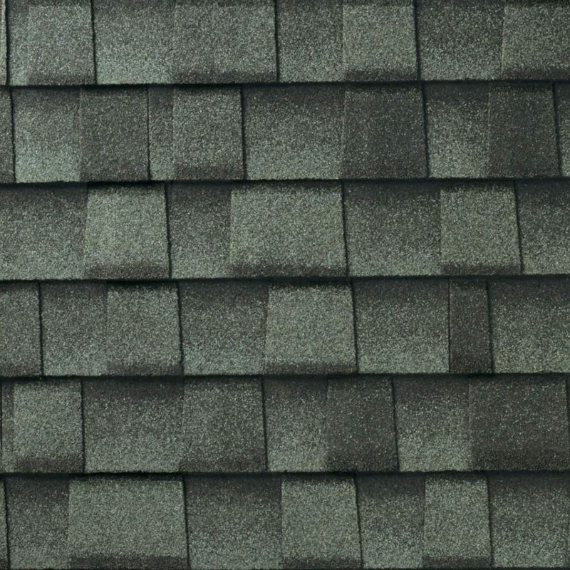Close-up of gray asphalt roof shingles, arranged in a repeating pattern.
