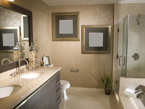 Bathroom with vanity, toilet, and shower. Two framed art pieces on the wall, neutral tones.