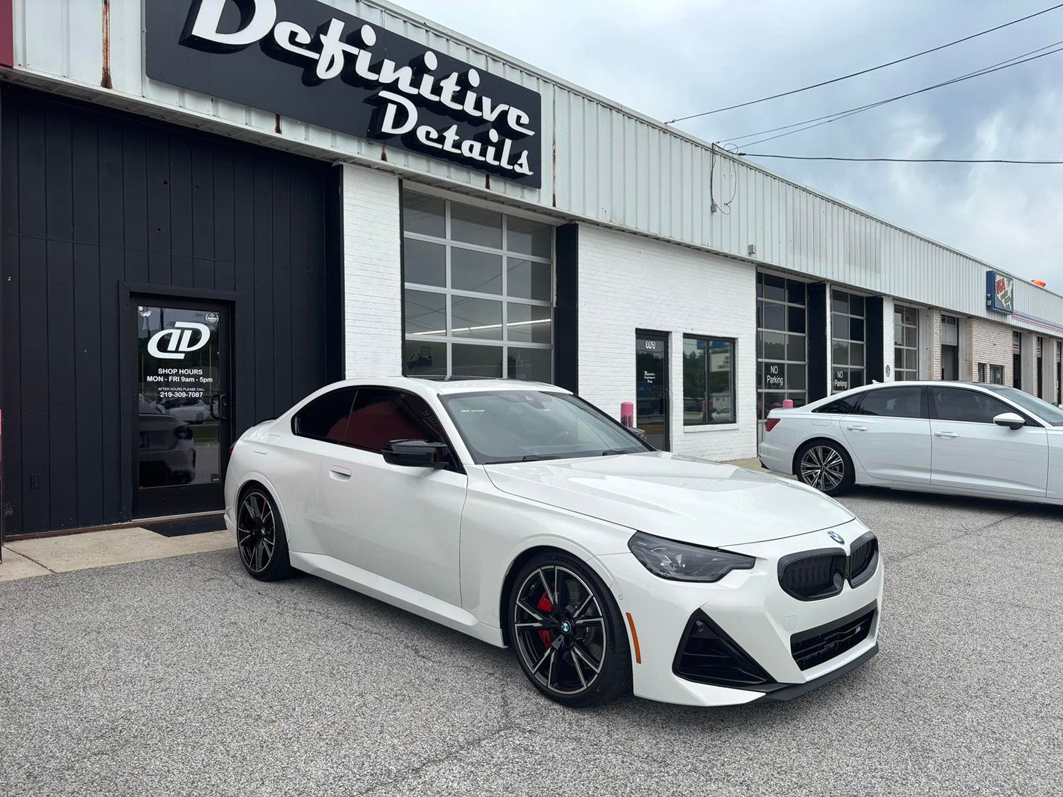 White BMW coupe in front of 