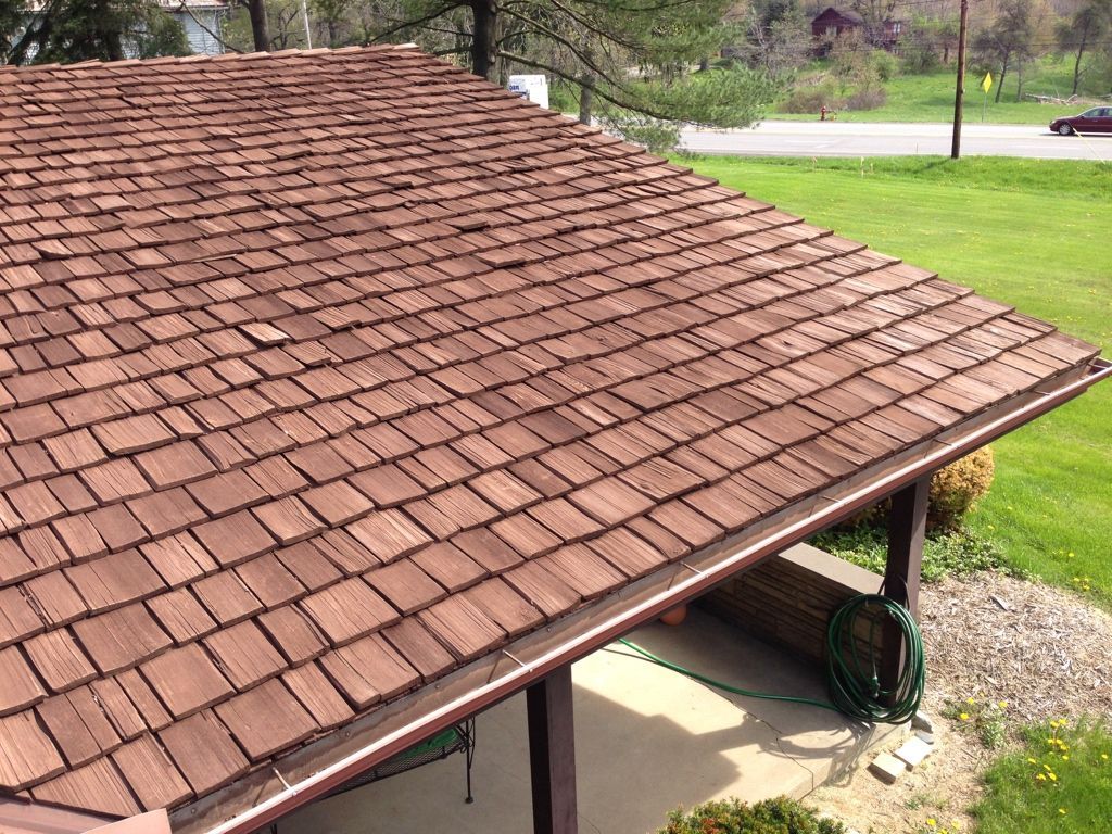 Brown shingle roof on a small pavilion in a grassy park area