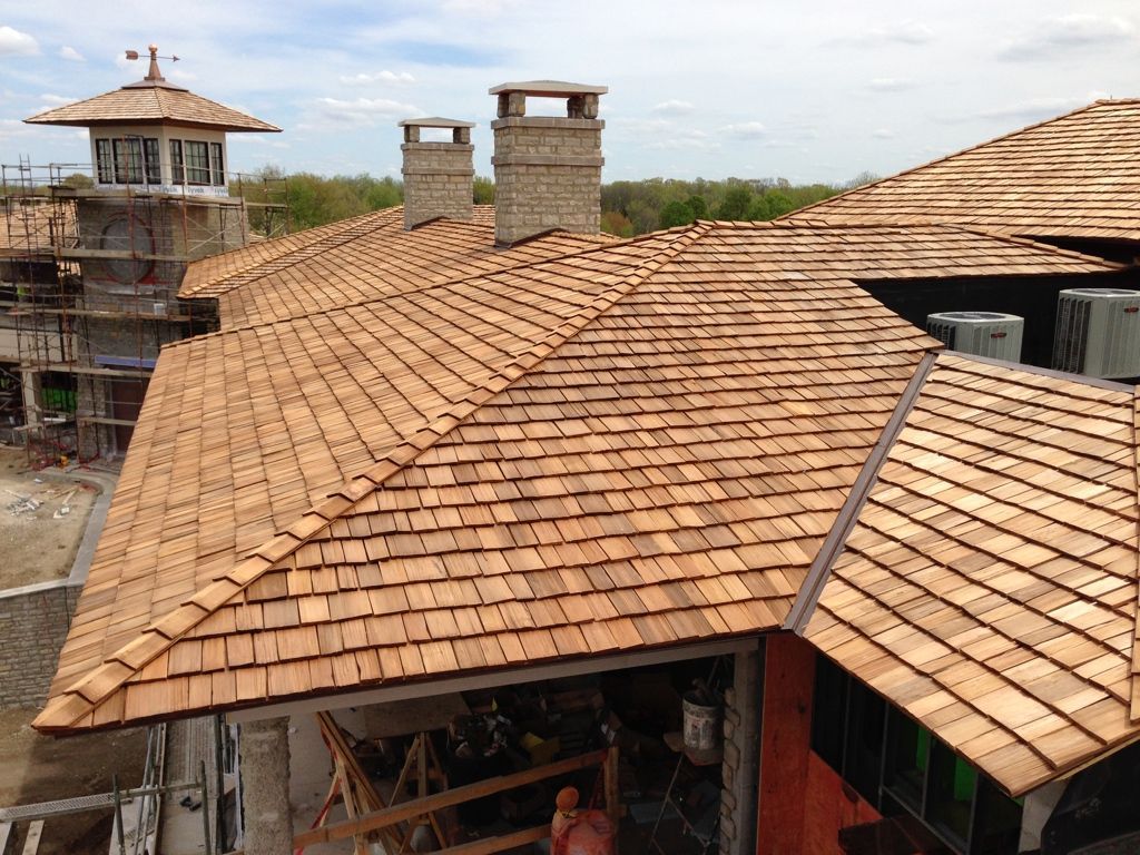 Terracotta tiled rooftops and chimneys on a building complex under construction