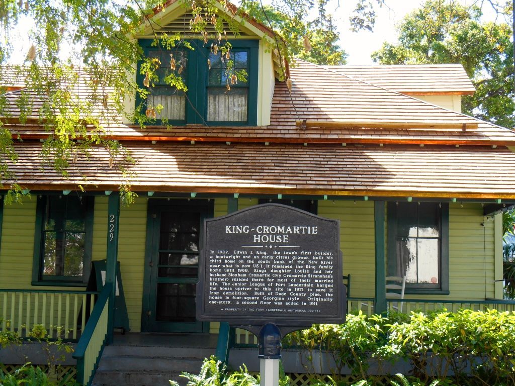 Historic King Kamehameha House with a plaque, green shutters, and leafy exterior in daylight