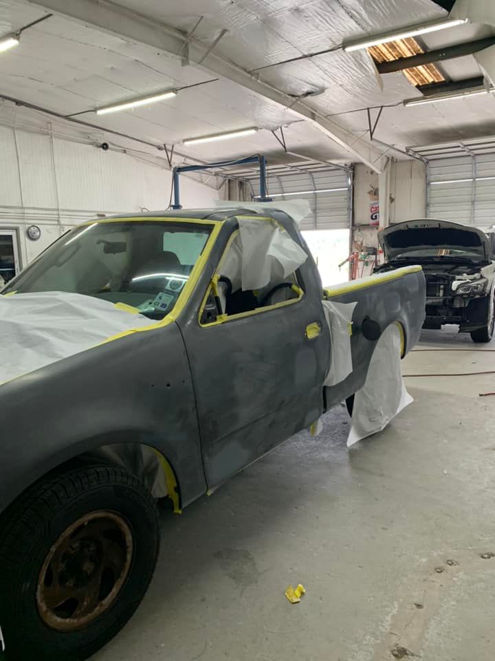 a truck is being painted in a garage .