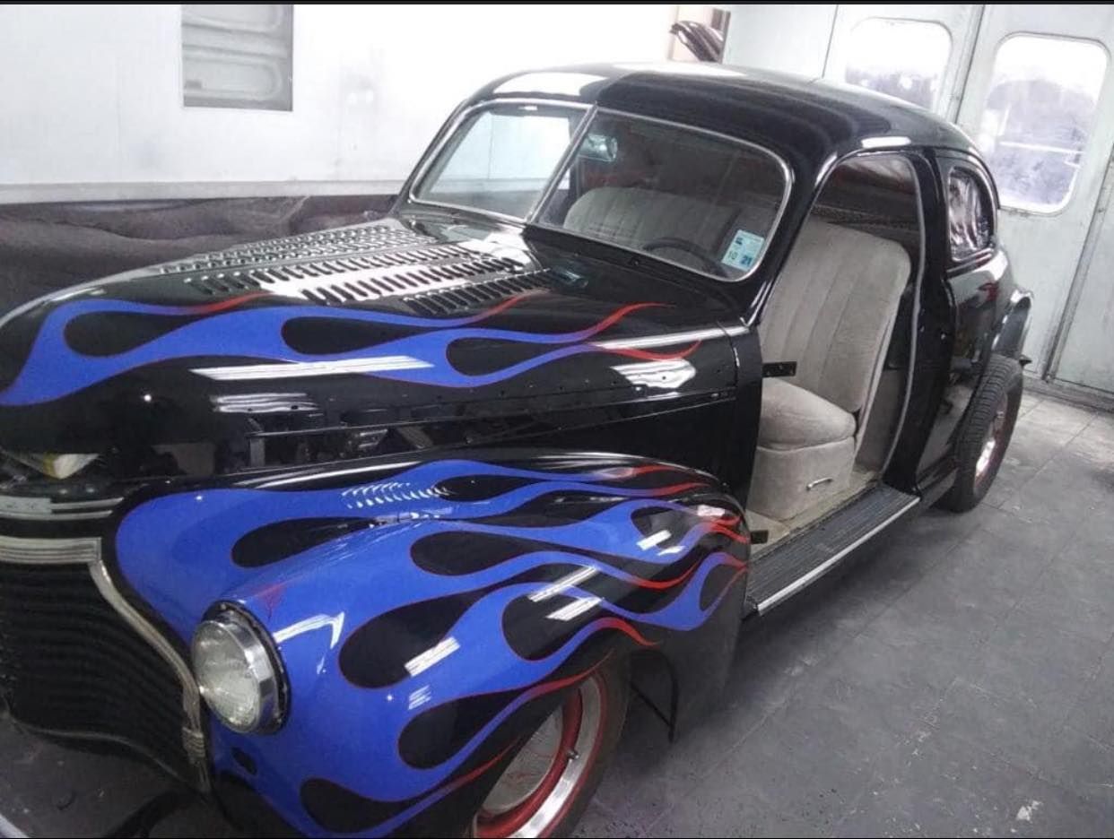 a black car with blue flames painted on it
