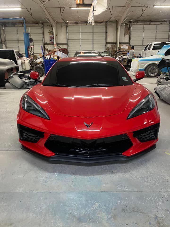 a red sports car is parked in a garage .