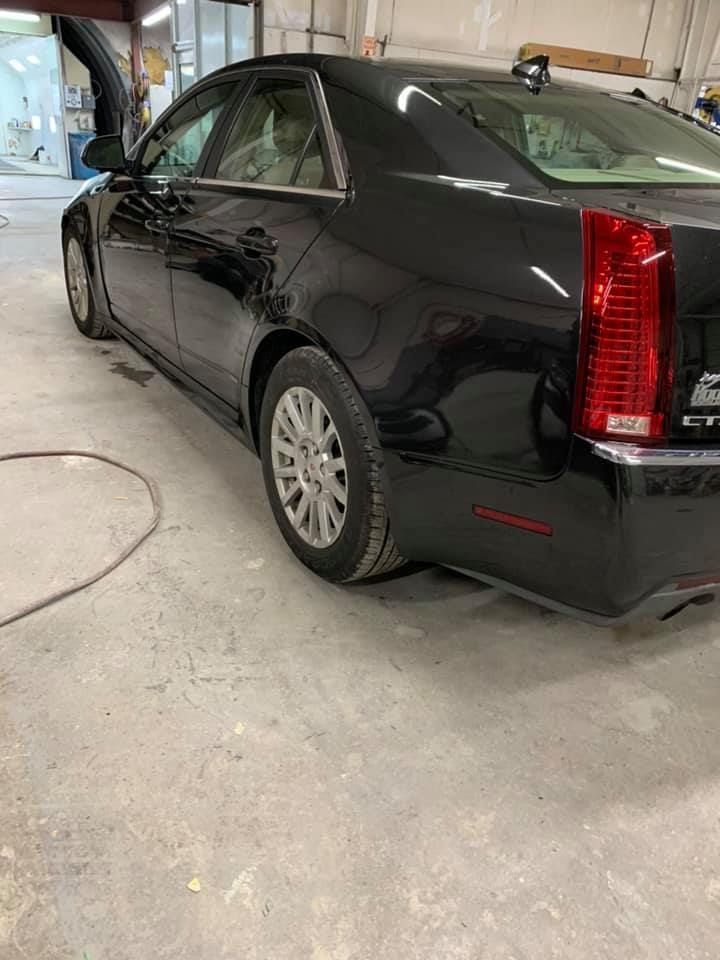 a black car is parked in a garage .