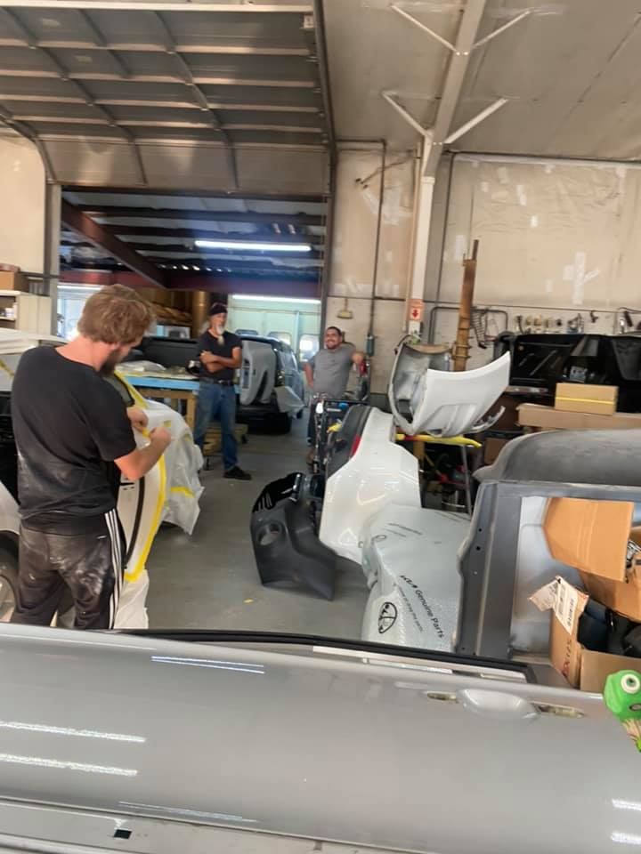 a man is working on a car in a garage .