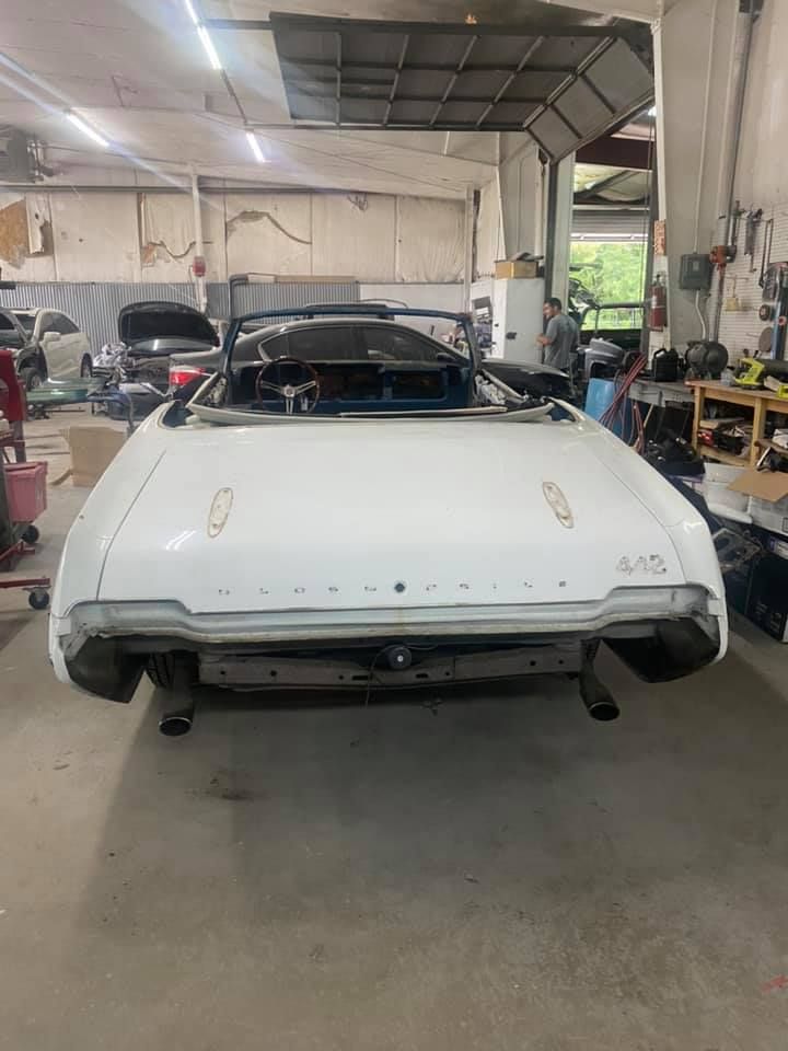 a white car is sitting in a garage .