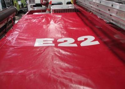 Red emergency slide or ramp marked “E22” in white on a red surface