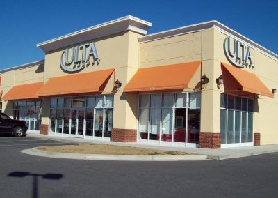 Ulta Beauty storefront with orange awnings and glass windows on a sunny day