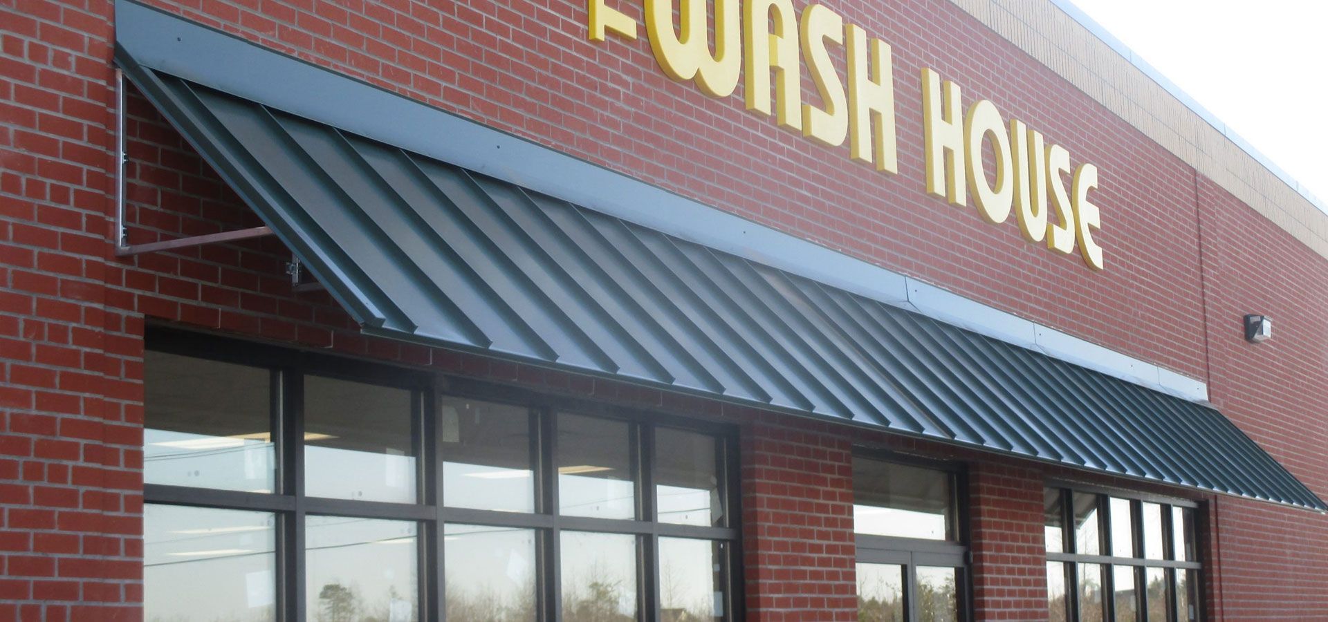 Jewish House sign above storefront windows and red brick exterior