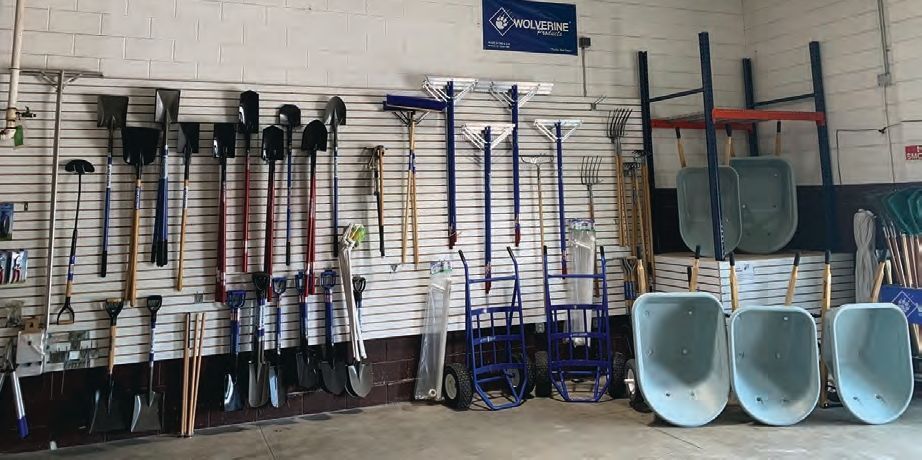 A bunch of wheelbarrows are lined up in a row