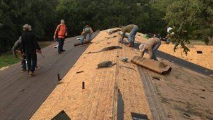 Team repairing roof