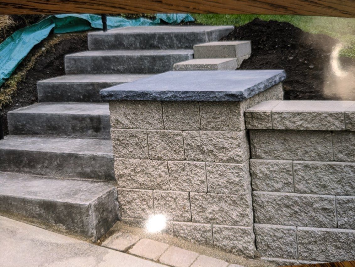 A set of stairs leading up to a stone wall