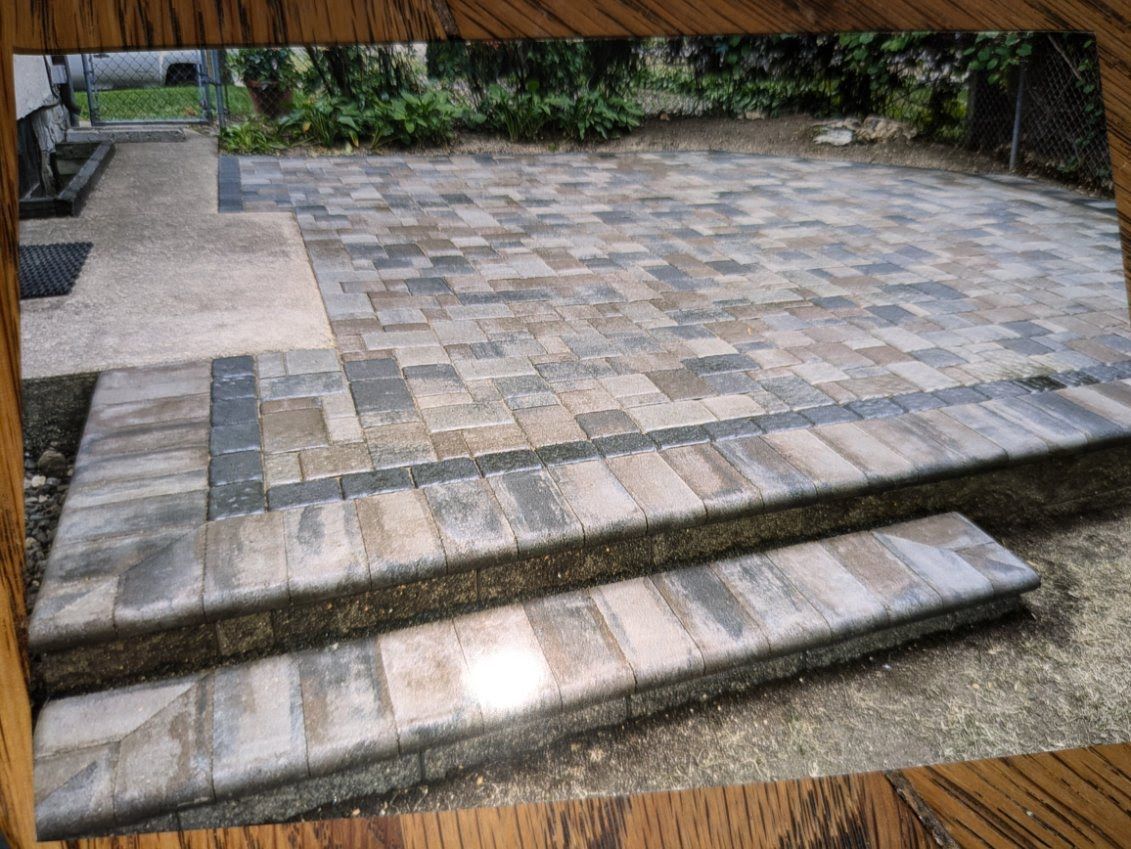 A picture of a patio with steps and a wooden frame