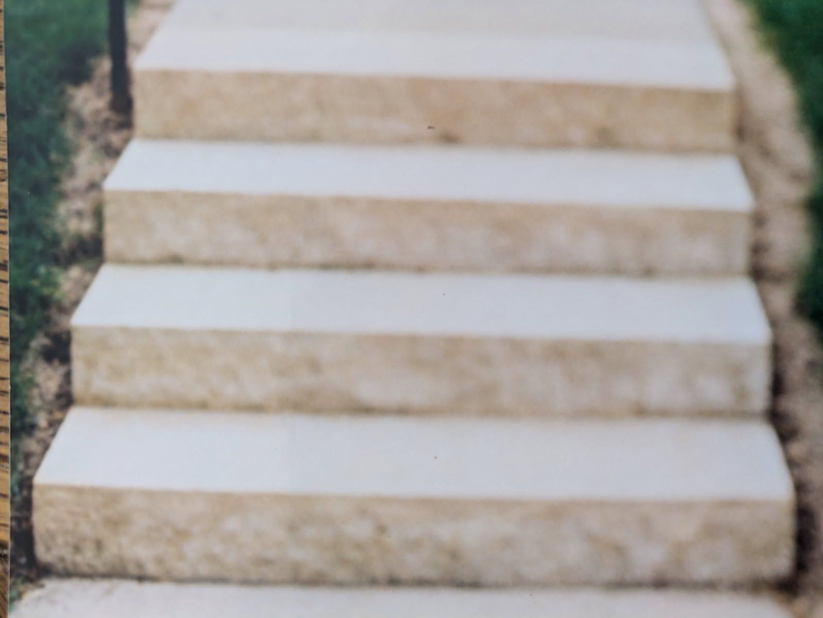 A set of stairs leading up to a grassy area.