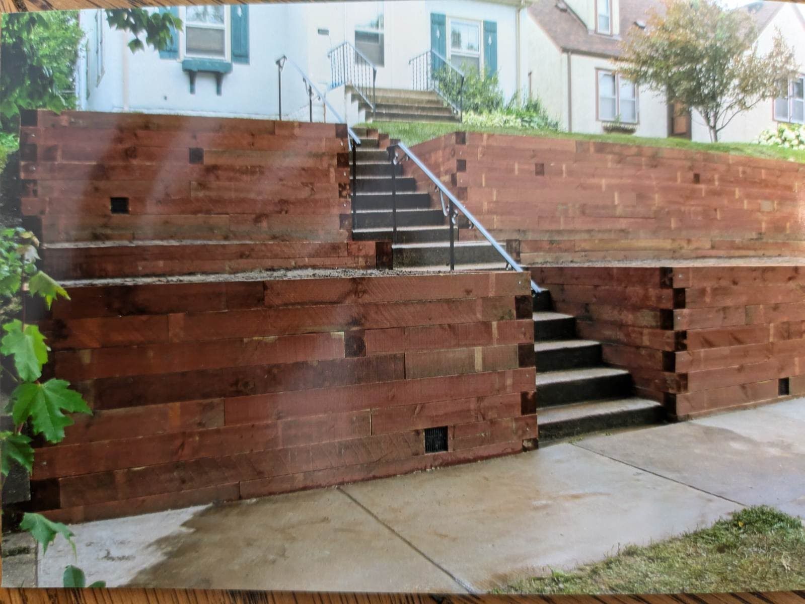 A brick wall with stairs leading up to a house