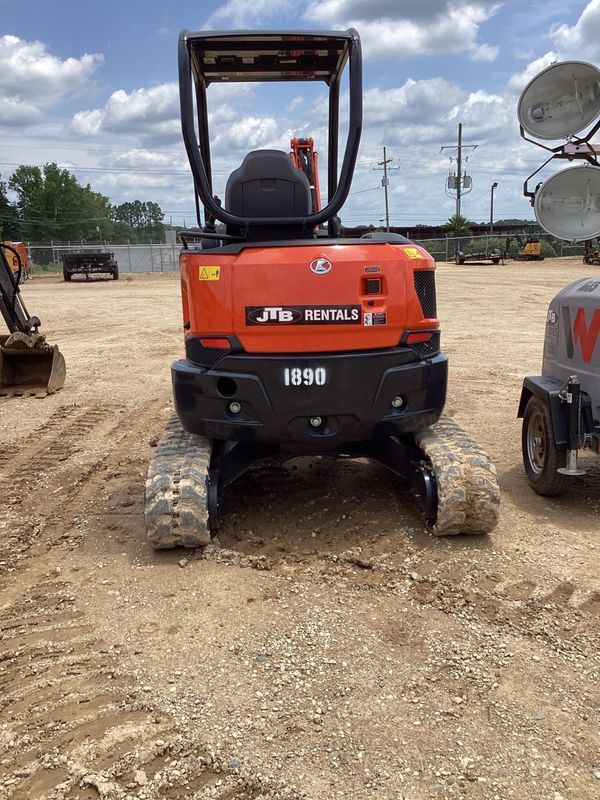 Orange Kubota mini excavator, model 1890, on a construction site.