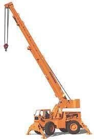 Orange mobile crane with raised boom and hook, outdoors.