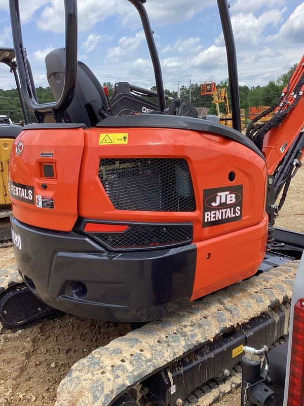 Orange and black Kubota excavator, JTB Rentals logo, on tracks.