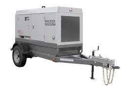 Gray Wacker Neuson generator on a trailer, ready for transport.