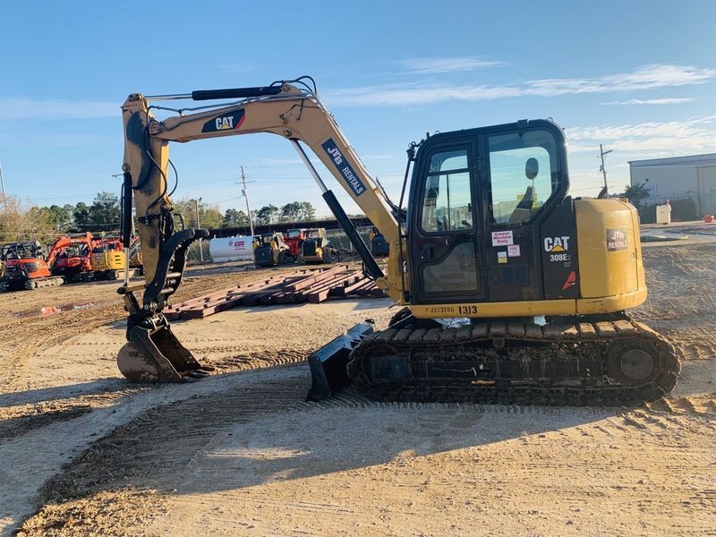 Yellow Caterpillar excavator on a construction site.